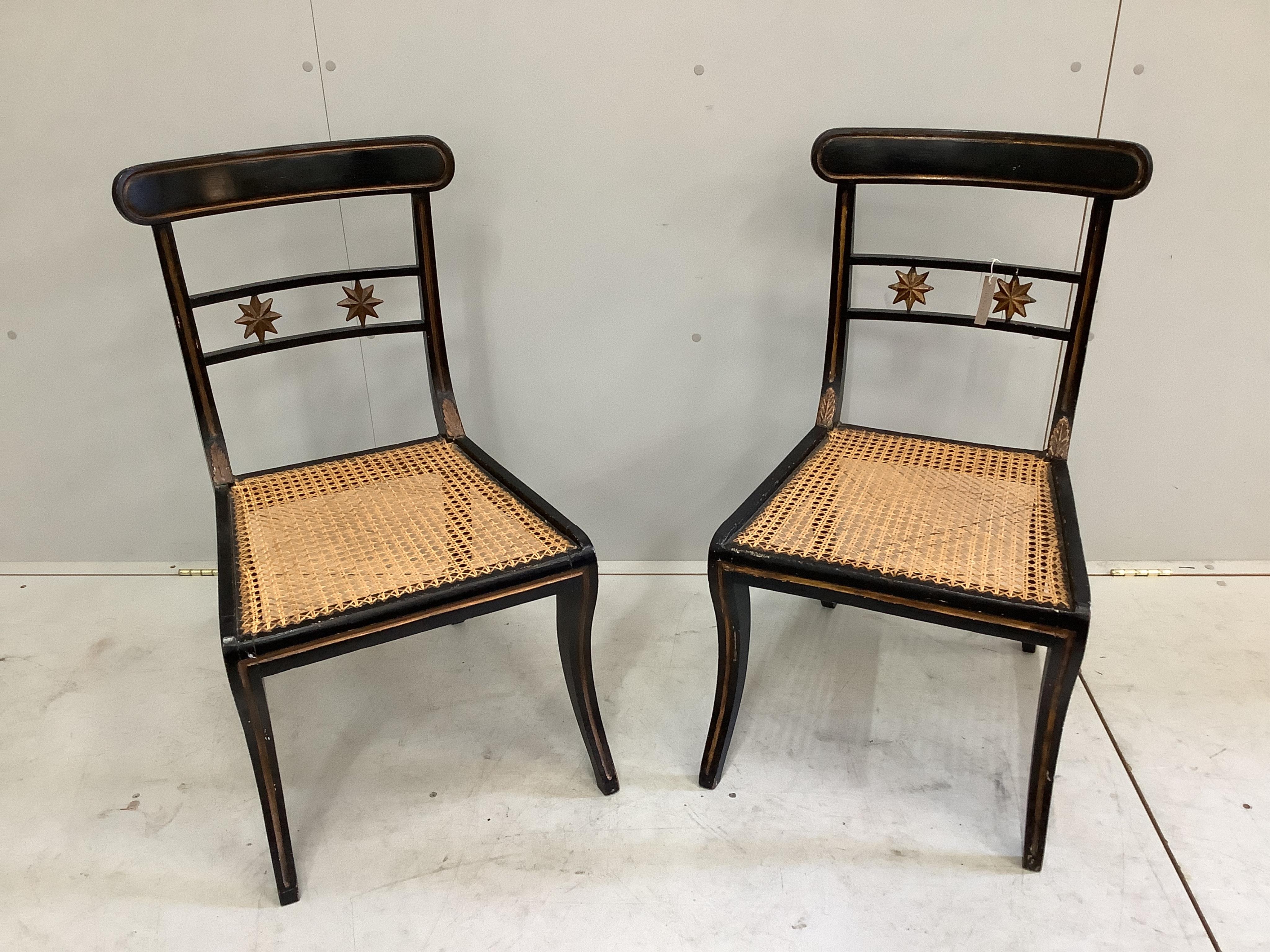 A pair of Regency painted parcelgilt cane seat dining chairs